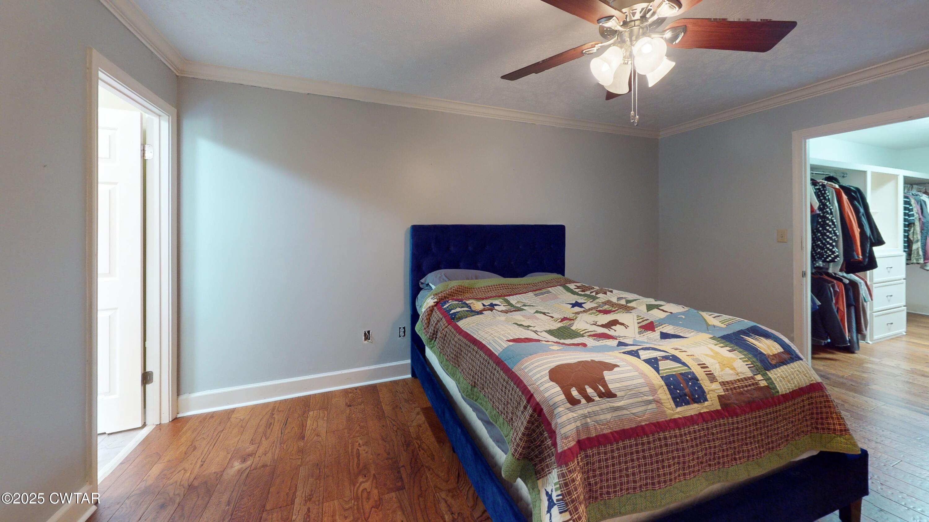 783 Sharps Ferry Road Newbern, TN 38059 - Photo 22 of 50 a bedroom with a bed and a chandelier