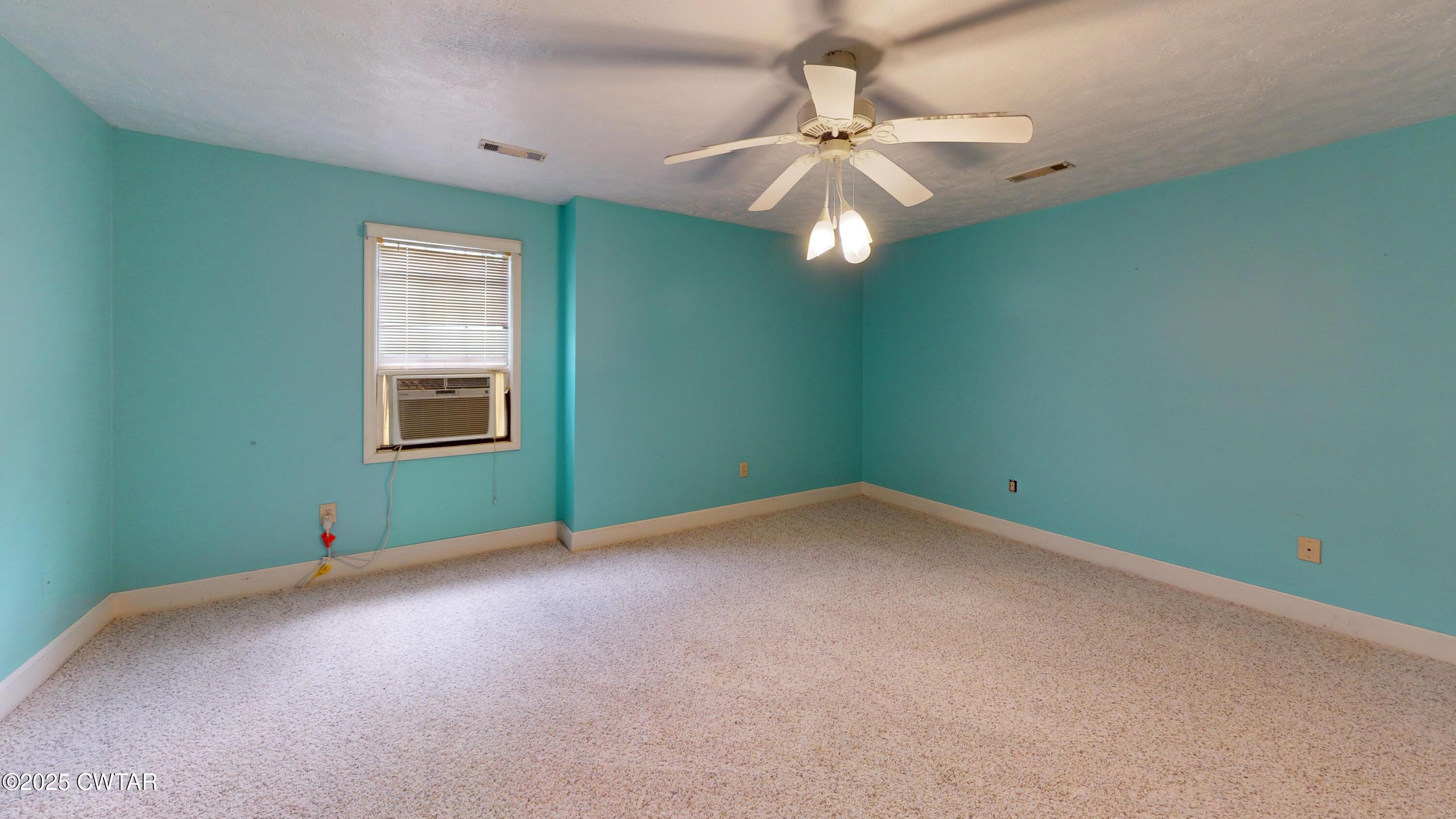 783 Sharps Ferry Road Newbern, TN 38059 - Photo 32 of 50 an empty room with a window and a fan