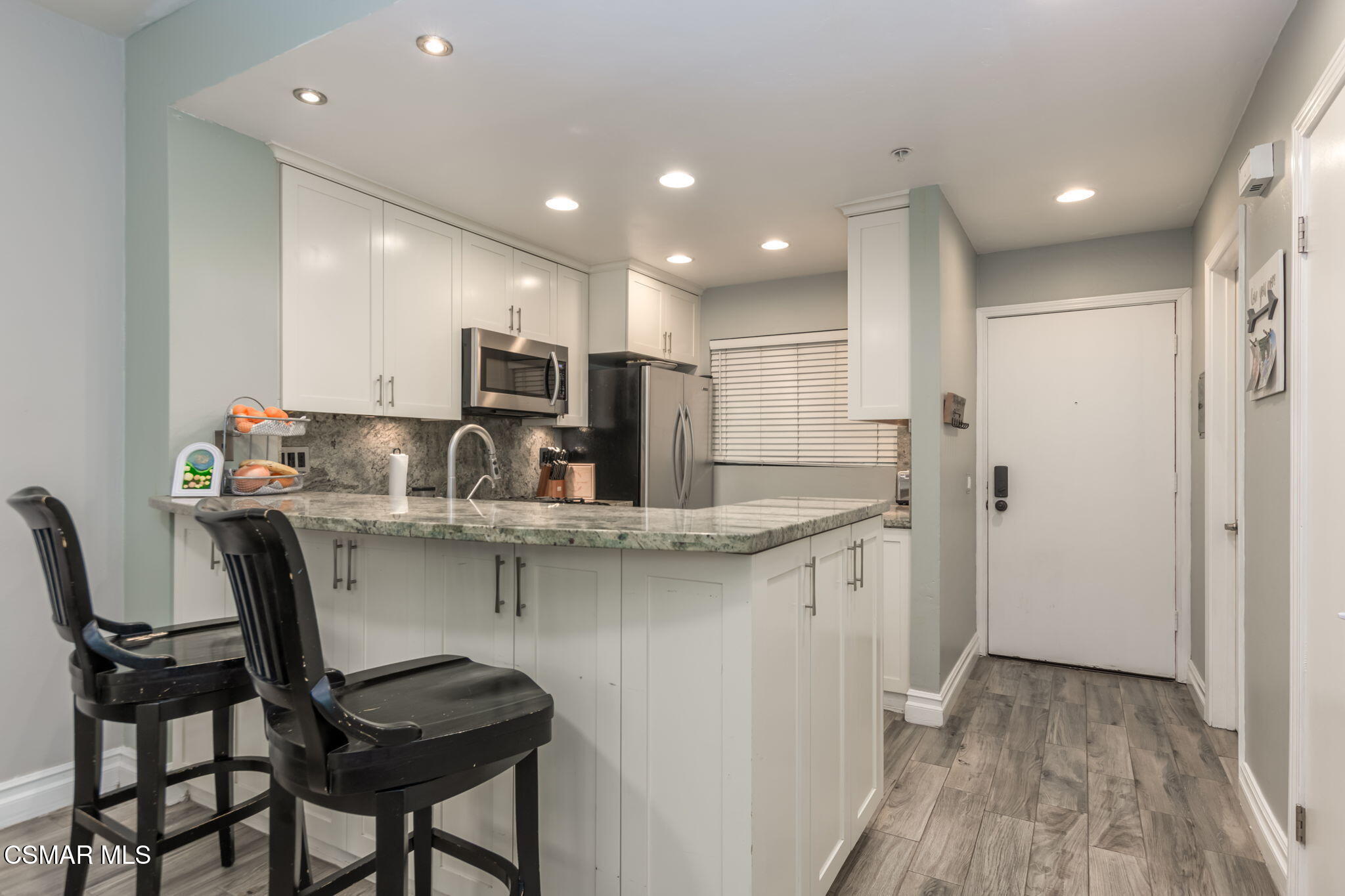785 Arneill Road, Unit 47 Camarillo, CA 93010 - Photo 3 of 25 a kitchen with kitchen island granite countertop wooden cabinets and stainless steel appliances