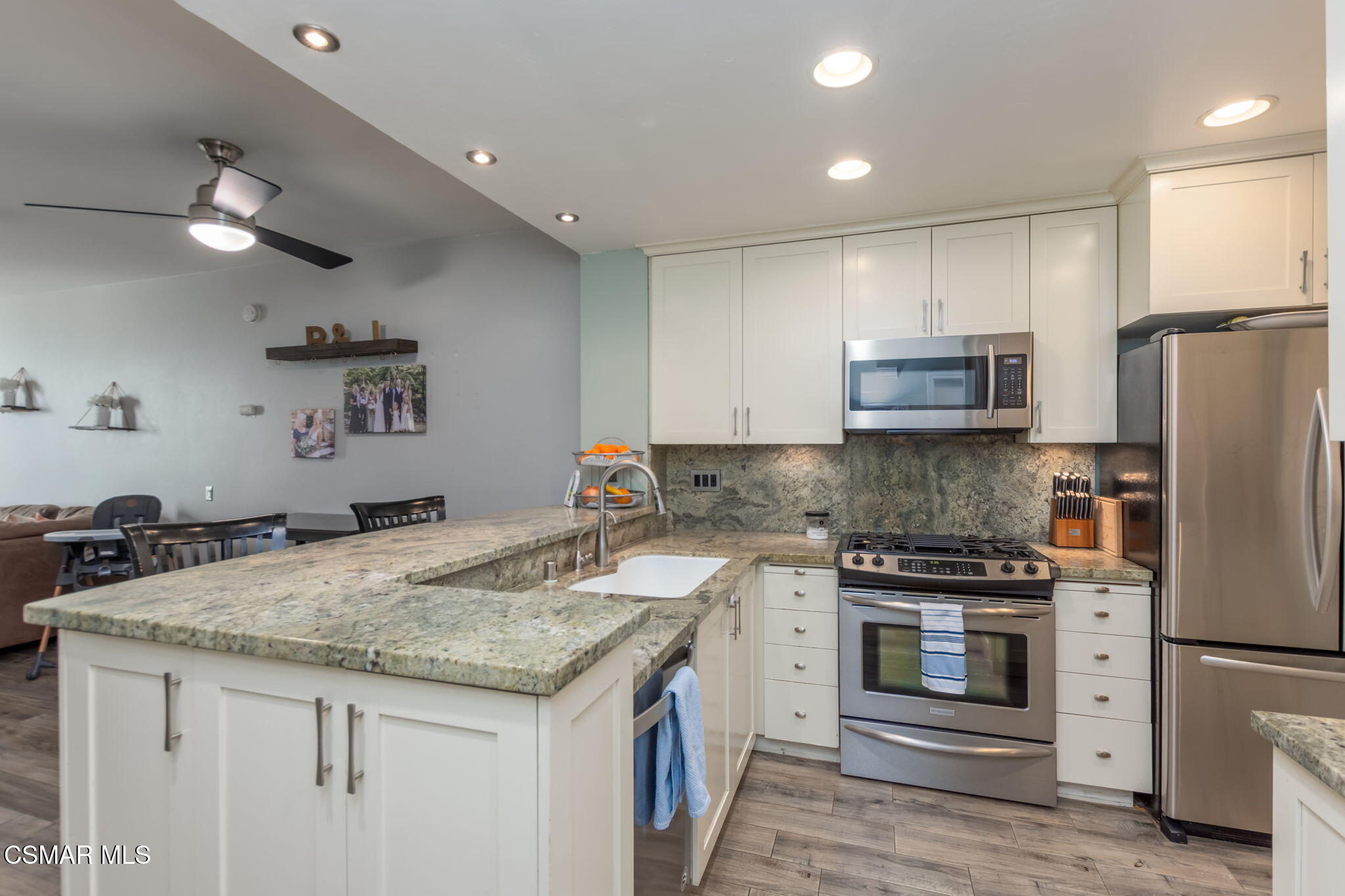 785 Arneill Road, Unit 47 Camarillo, CA 93010 - Photo 4 of 25 a kitchen with granite countertop a stove and a refrigerator