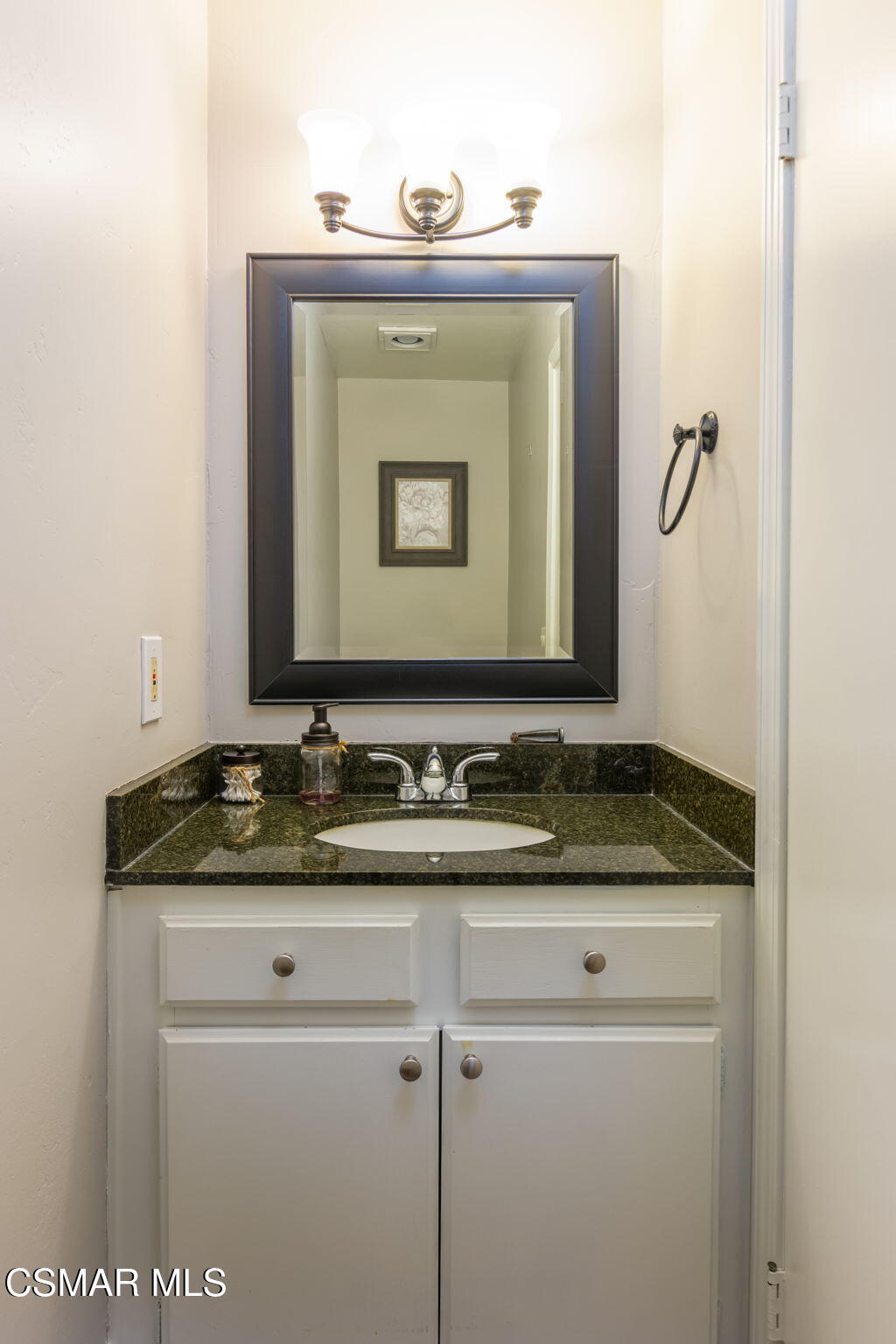 785 Arneill Road, Unit 47 Camarillo, CA 93010 - Photo 7 of 25 a bathroom with a granite countertop sink and a mirror