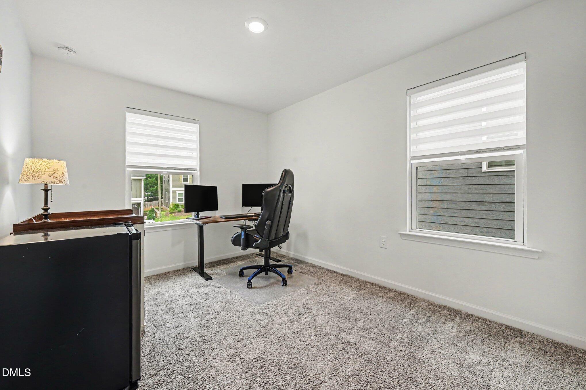 574 Hacksaw Trail Raleigh, NC 27610 - Photo 17 of 28 a view of a workspace with furniture and a window