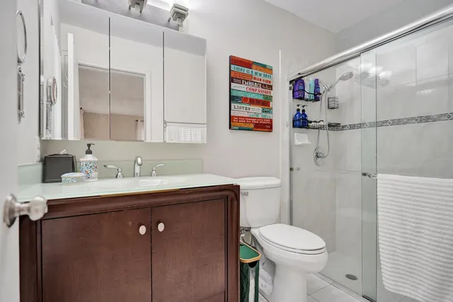 a bedroom with bed and a potted plant