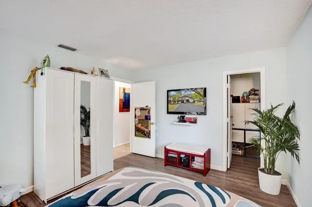 a bathroom with a granite countertop sink toilet and a mirror