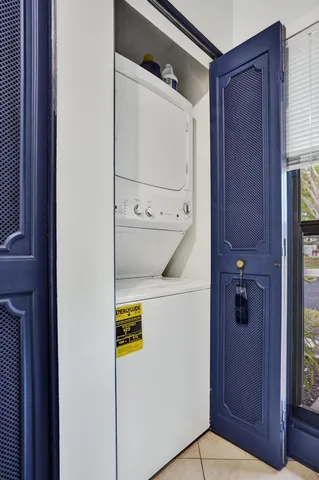 a front view of a house with a yard and table and chairs under an umbrella