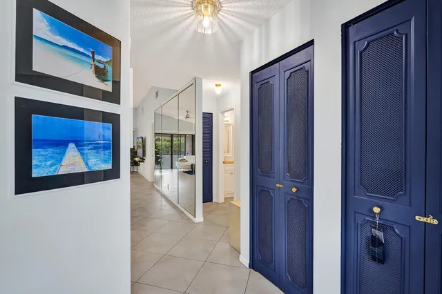 a view of a hallway with wooden floor and cabinet