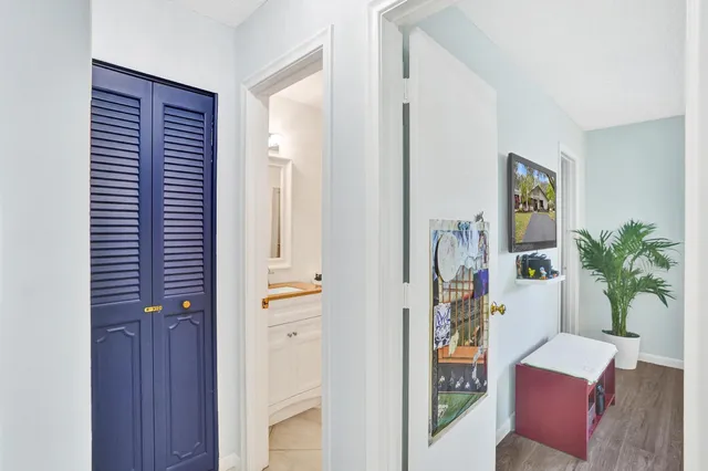 a view of hallway with furniture and a potted plant