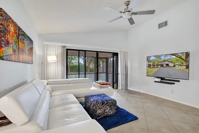 a bedroom with furniture and large windows