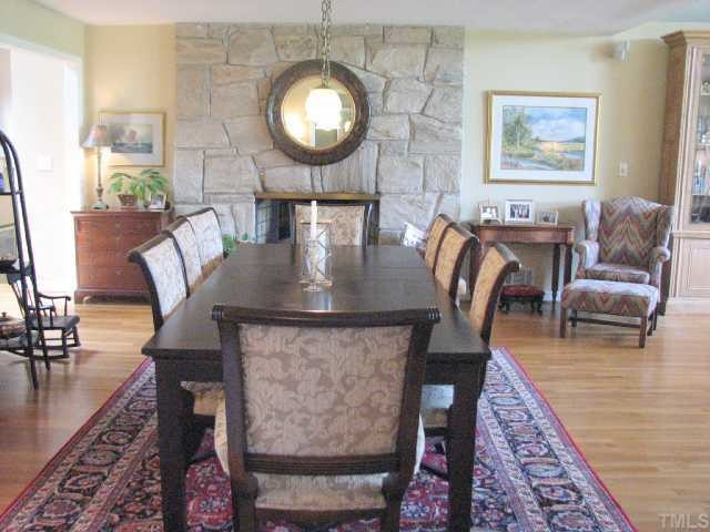 1409 Hunting Ridge Road Raleigh, NC 27615 - Photo 10 of 12 The dining room features a majestic stone fireplace. There is another fireplace in the lower level. Dining Room