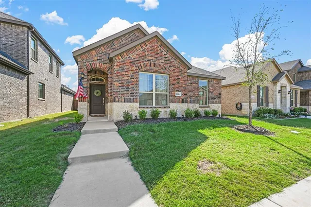 a front view of a house with a yard and porch