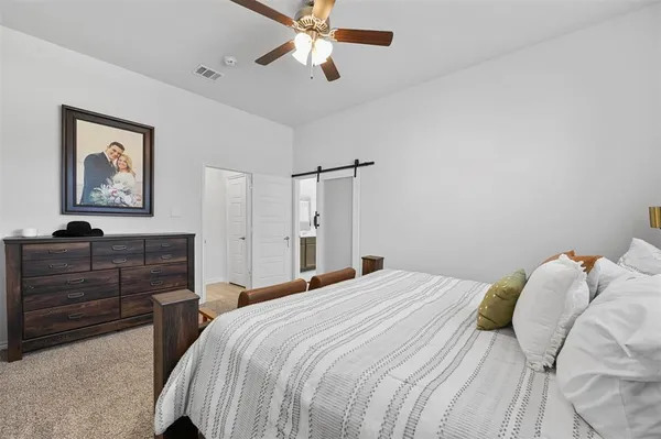 a bedroom with a bed and a dresser