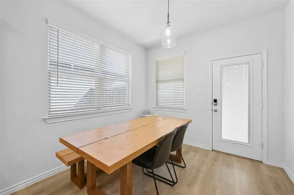 a view of a dining room with furniture and wooden floor
