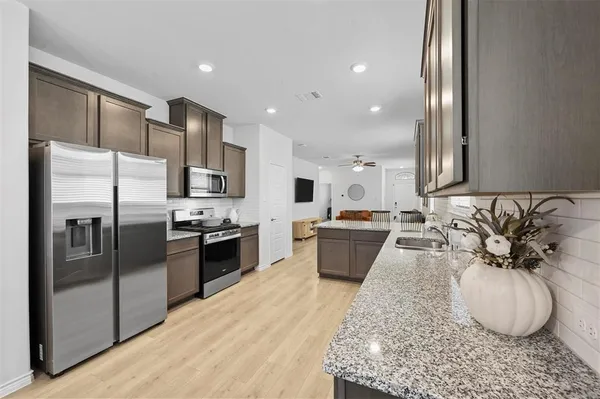 a large kitchen with stainless steel appliances kitchen island granite countertop a large counter top stainless steel appliances and cabinets