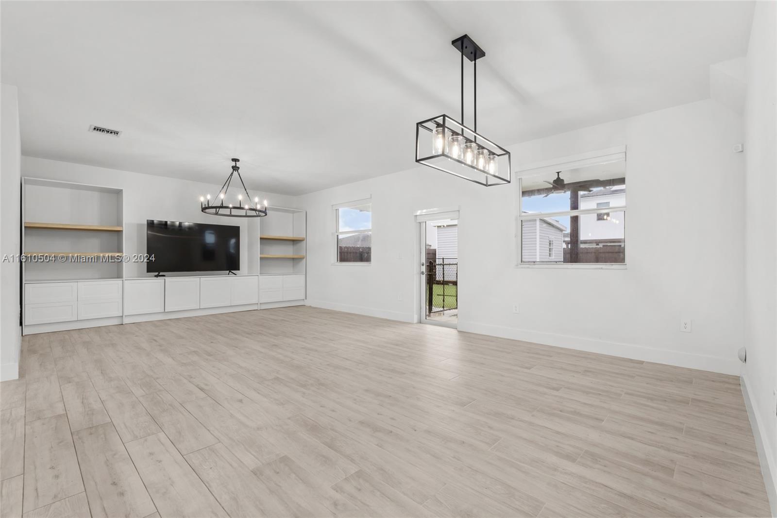 12743 Southwest 211th Street Miami, FL 33177 - Photo 13 of 38 a view of a kitchen with a sink and dishwasher wooden floor