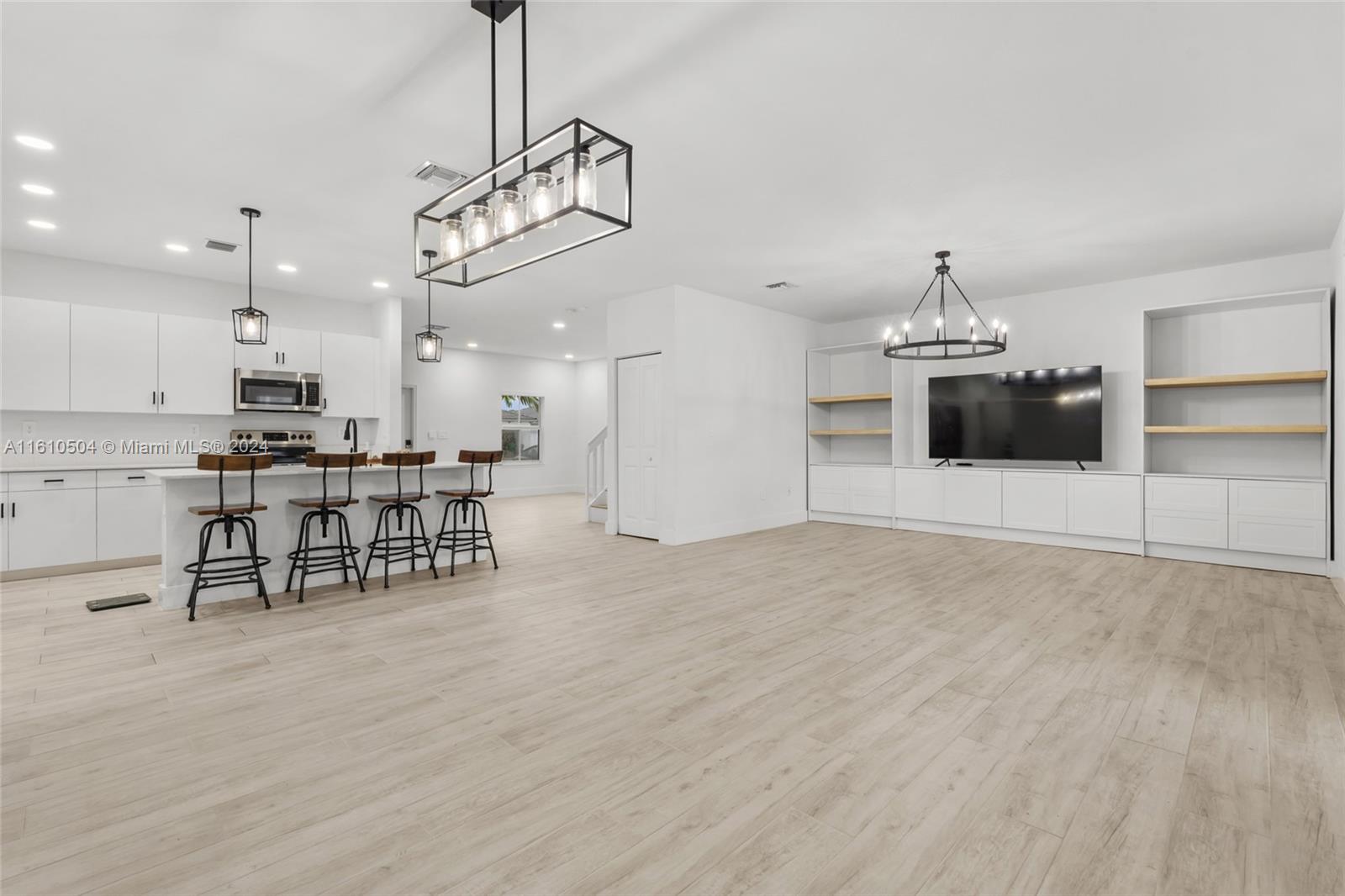 12743 Southwest 211th Street Miami, FL 33177 - Photo 15 of 38 a view of a kitchen with a table and chairs