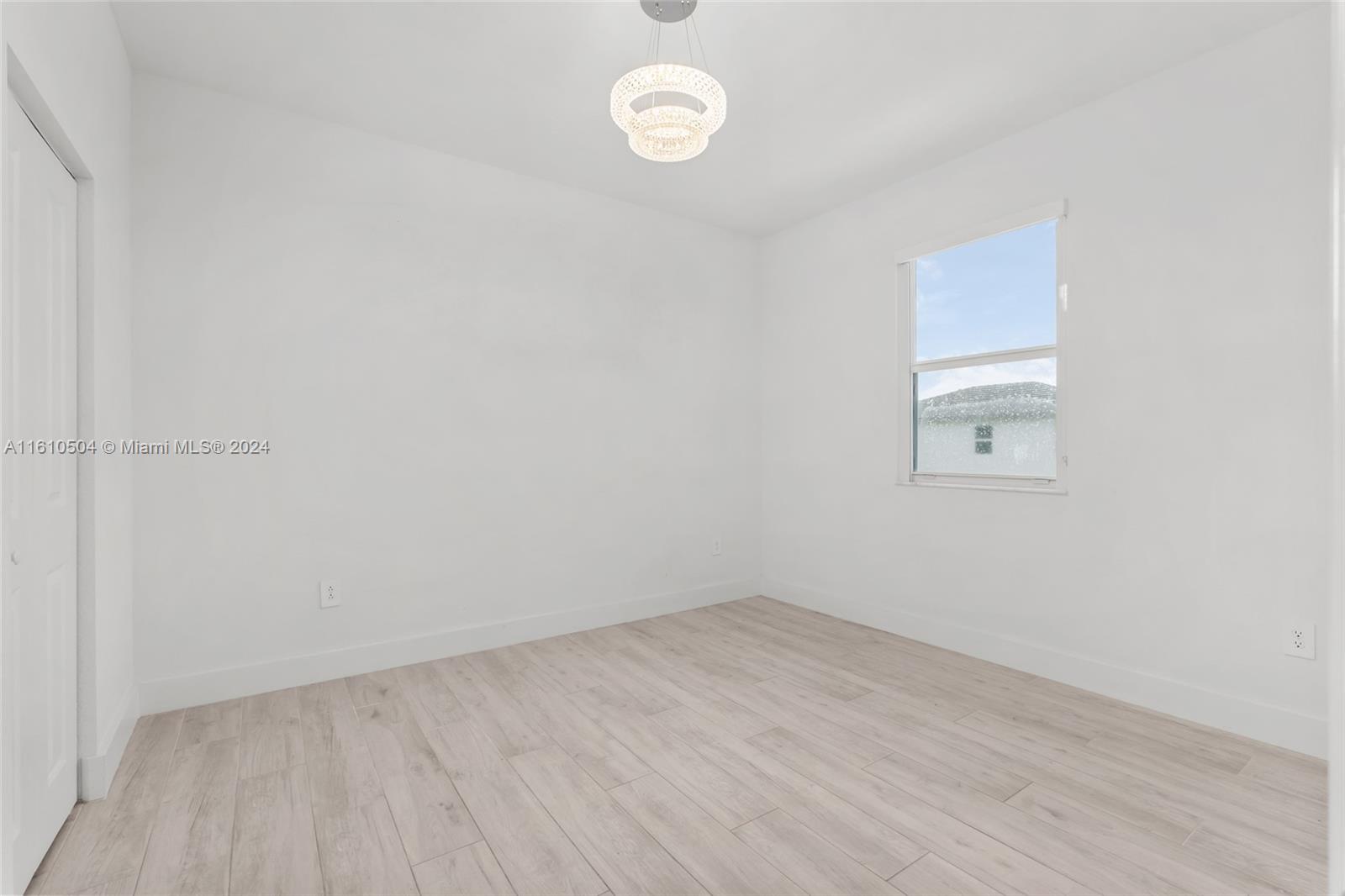 12743 Southwest 211th Street Miami, FL 33177 - Photo 22 of 38 a view of a room with wooden floor and window