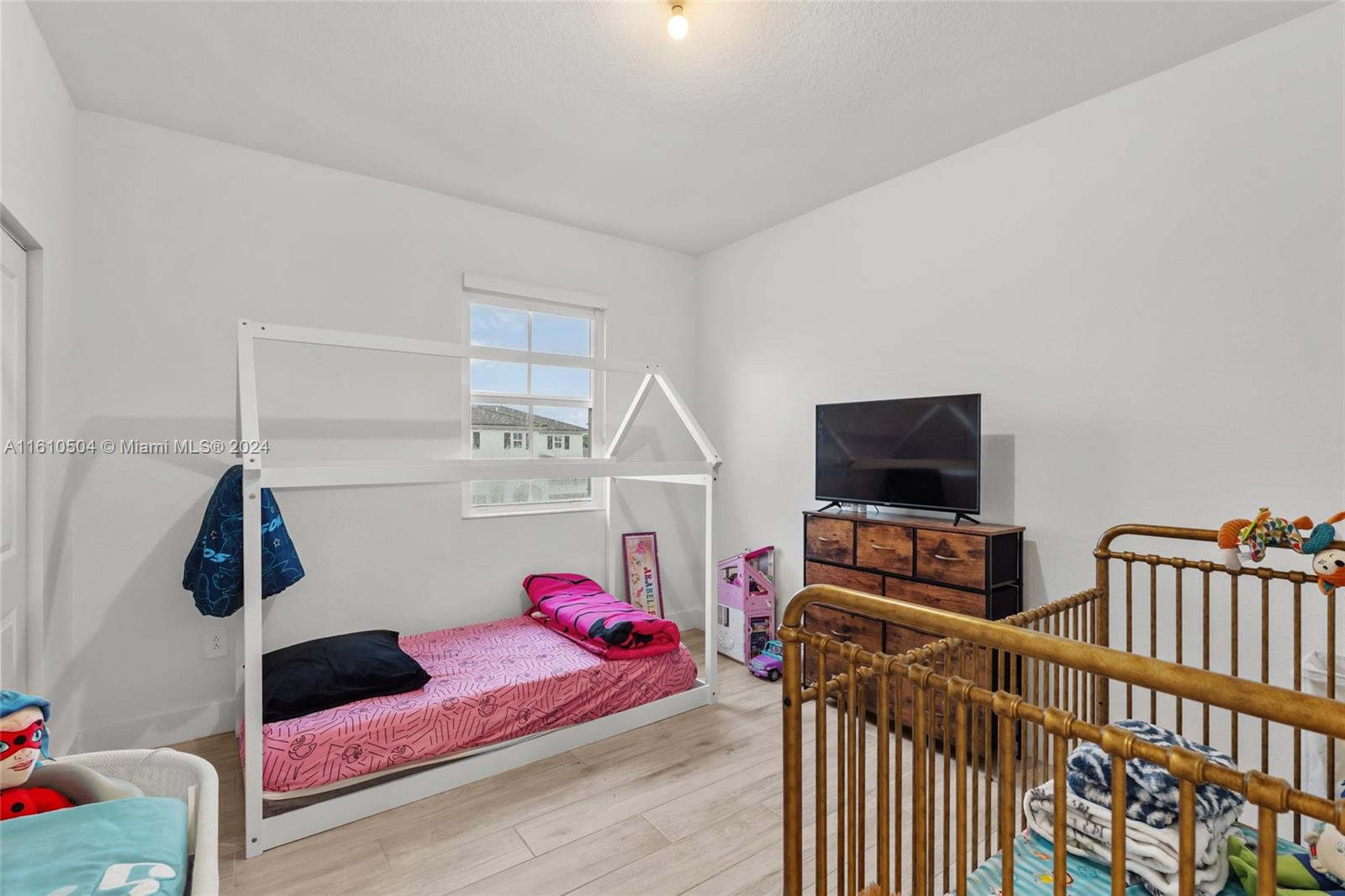 12743 Southwest 211th Street Miami, FL 33177 - Photo 24 of 38 a bedroom with furniture and a flat screen tv