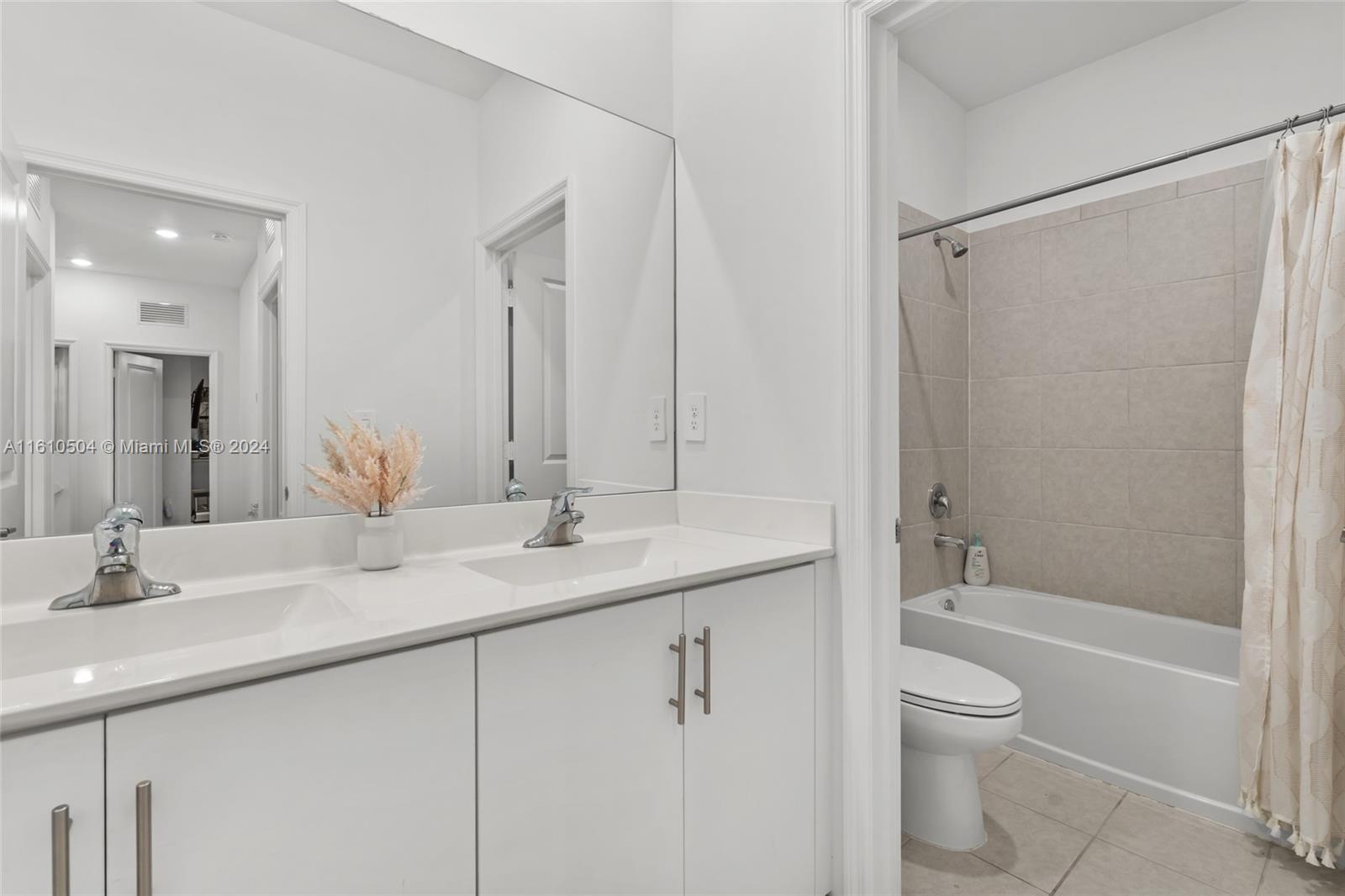 12743 Southwest 211th Street Miami, FL 33177 - Photo 25 of 38 a bathroom with a granite countertop sink a toilet and shower