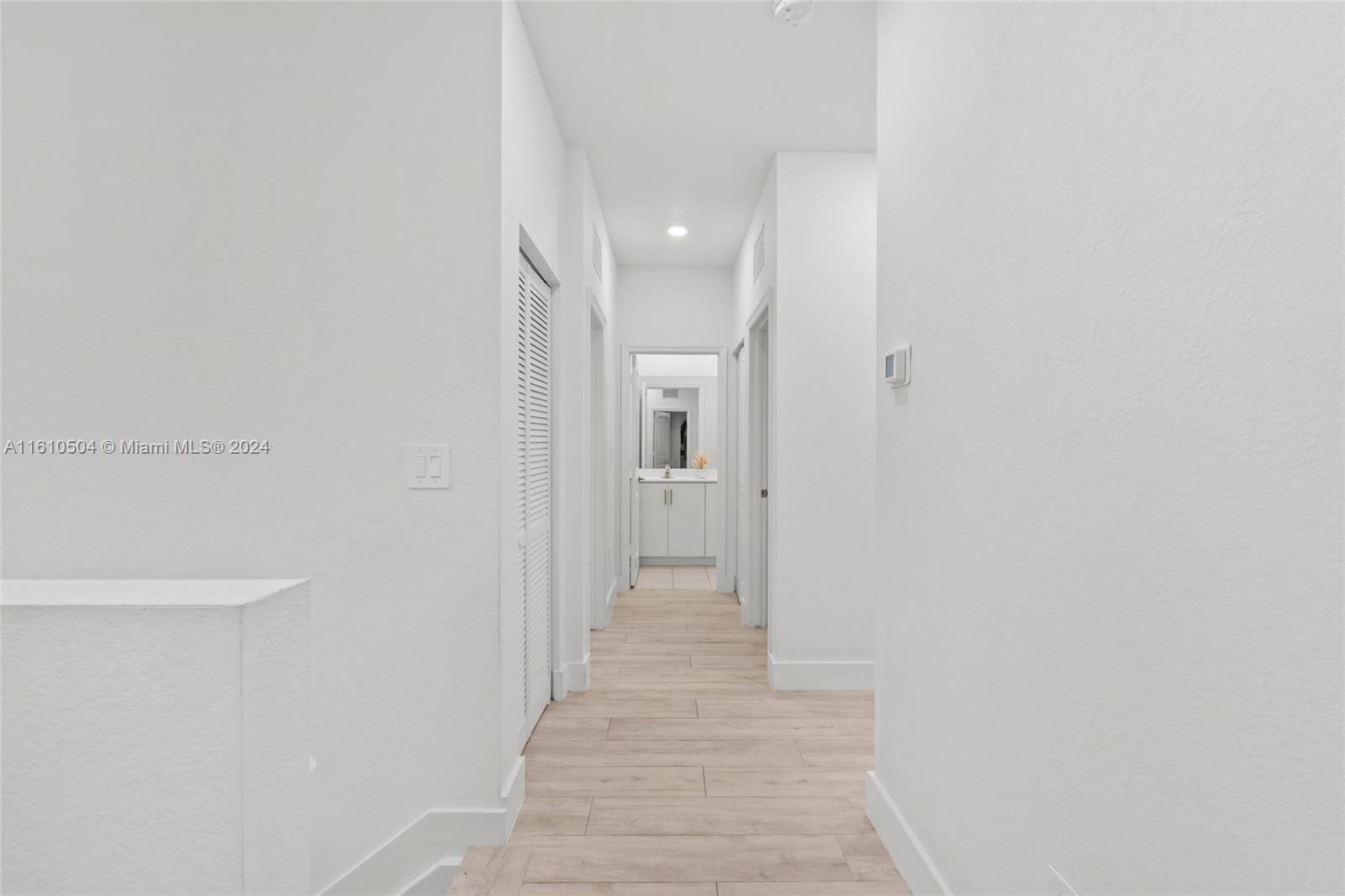 12743 Southwest 211th Street Miami, FL 33177 - Photo 26 of 38 a view of a hallway with wooden cabinets