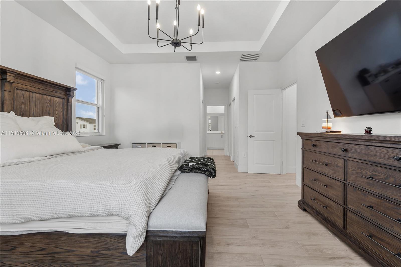 12743 Southwest 211th Street Miami, FL 33177 - Photo 28 of 38 a bedroom with a bed and a flat screen tv