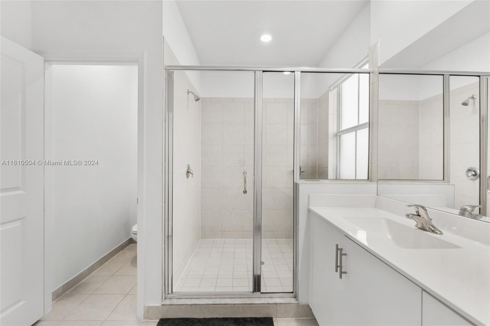 12743 Southwest 211th Street Miami, FL 33177 - Photo 29 of 38 a bathroom with a shower sink and mirror