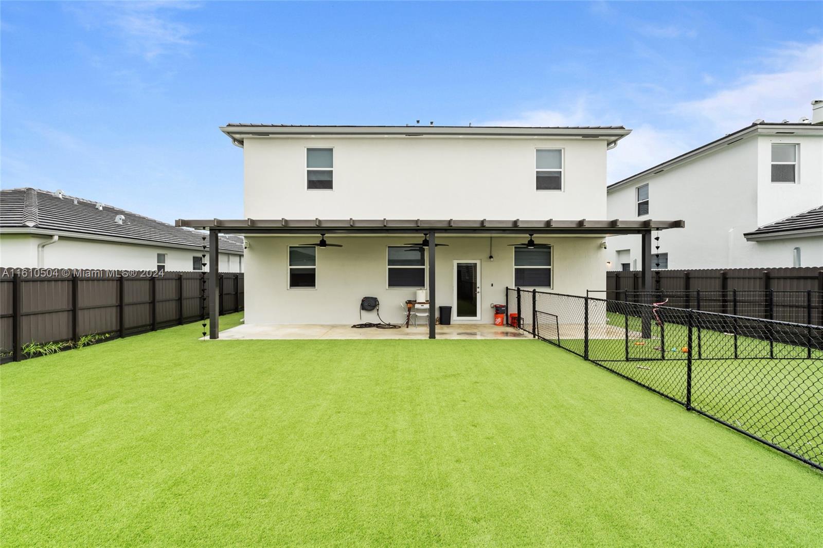 12743 Southwest 211th Street Miami, FL 33177 - Photo 32 of 38 a view of a house with backyard and sitting area