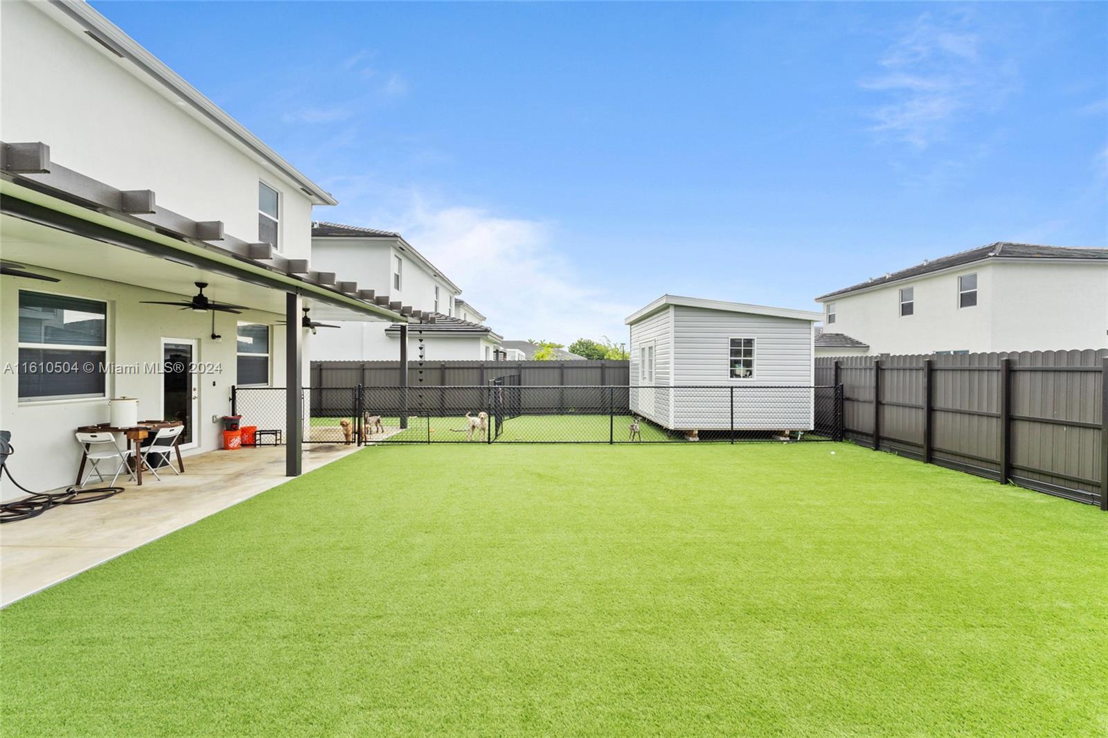 12743 Southwest 211th Street Miami, FL 33177 - Photo 35 of 38 a swimming pool with yard and outdoor seating