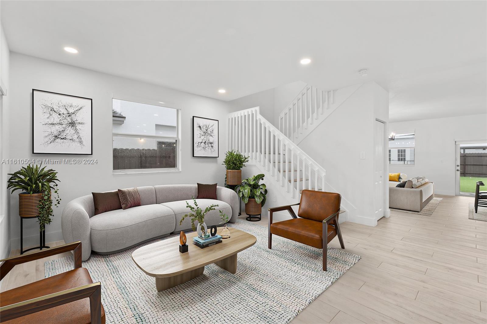 12743 Southwest 211th Street Miami, FL 33177 - Photo 4 of 38 a living room with furniture and wooden floor