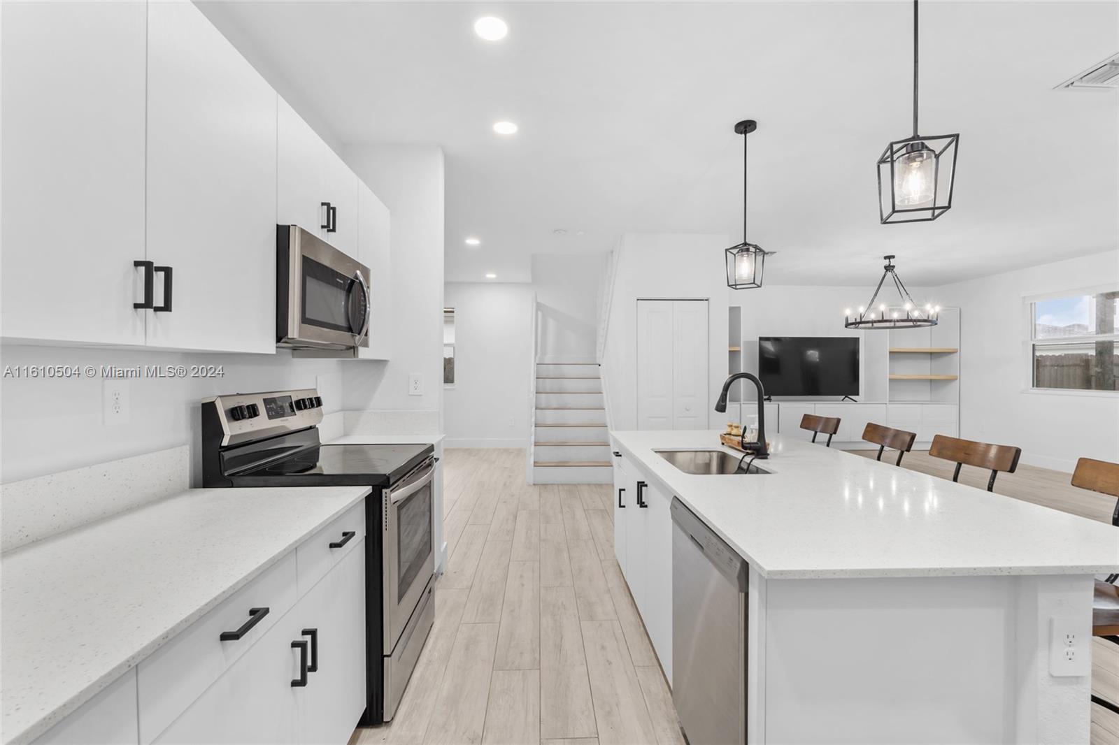 12743 Southwest 211th Street Miami, FL 33177 - Photo 7 of 38 a kitchen with stainless steel appliances a sink stove and refrigerator