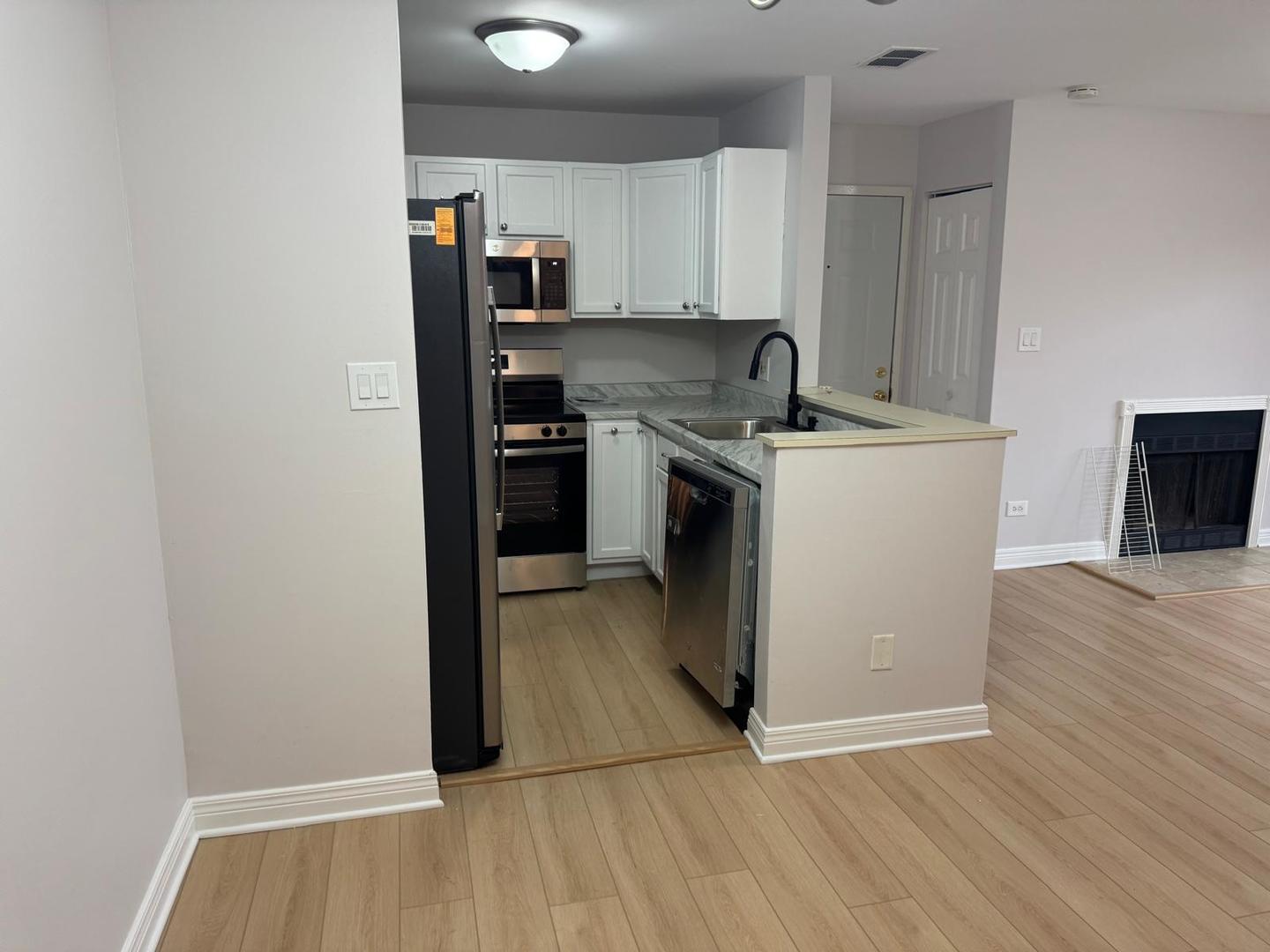 1935 North Hicks Road, Unit 106 Palatine, IL 60074 - Photo 7 of 16 a kitchen with a sink and a stove top oven