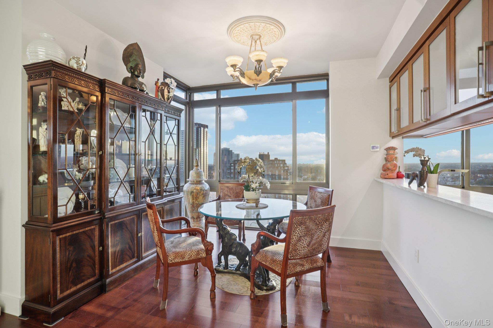 175 Huguenot Street, Unit 2403 New Rochelle, NY 10801 - Photo 13 of 30 a view of a dining room with furniture window and wooden floor