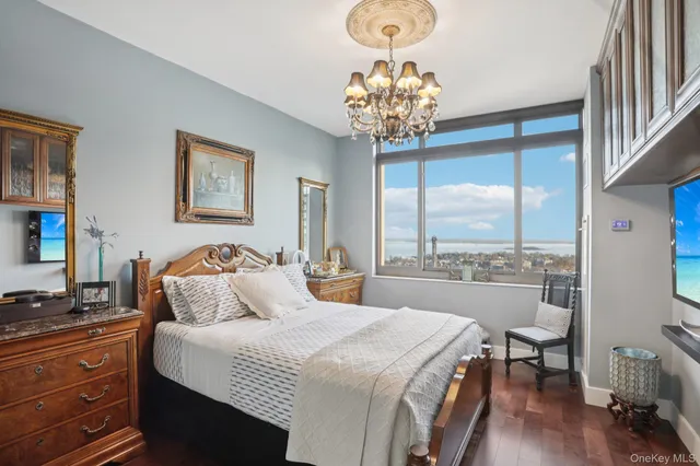 a bedroom with a bed and a chandelier