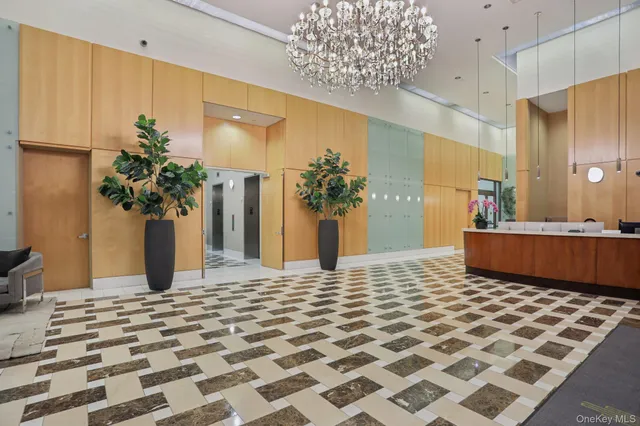 a hotel room with patio furniture and a potted plant