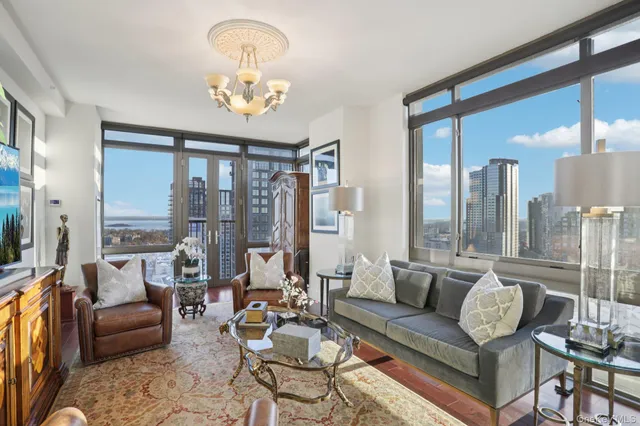 a living room with patio furniture and a large window