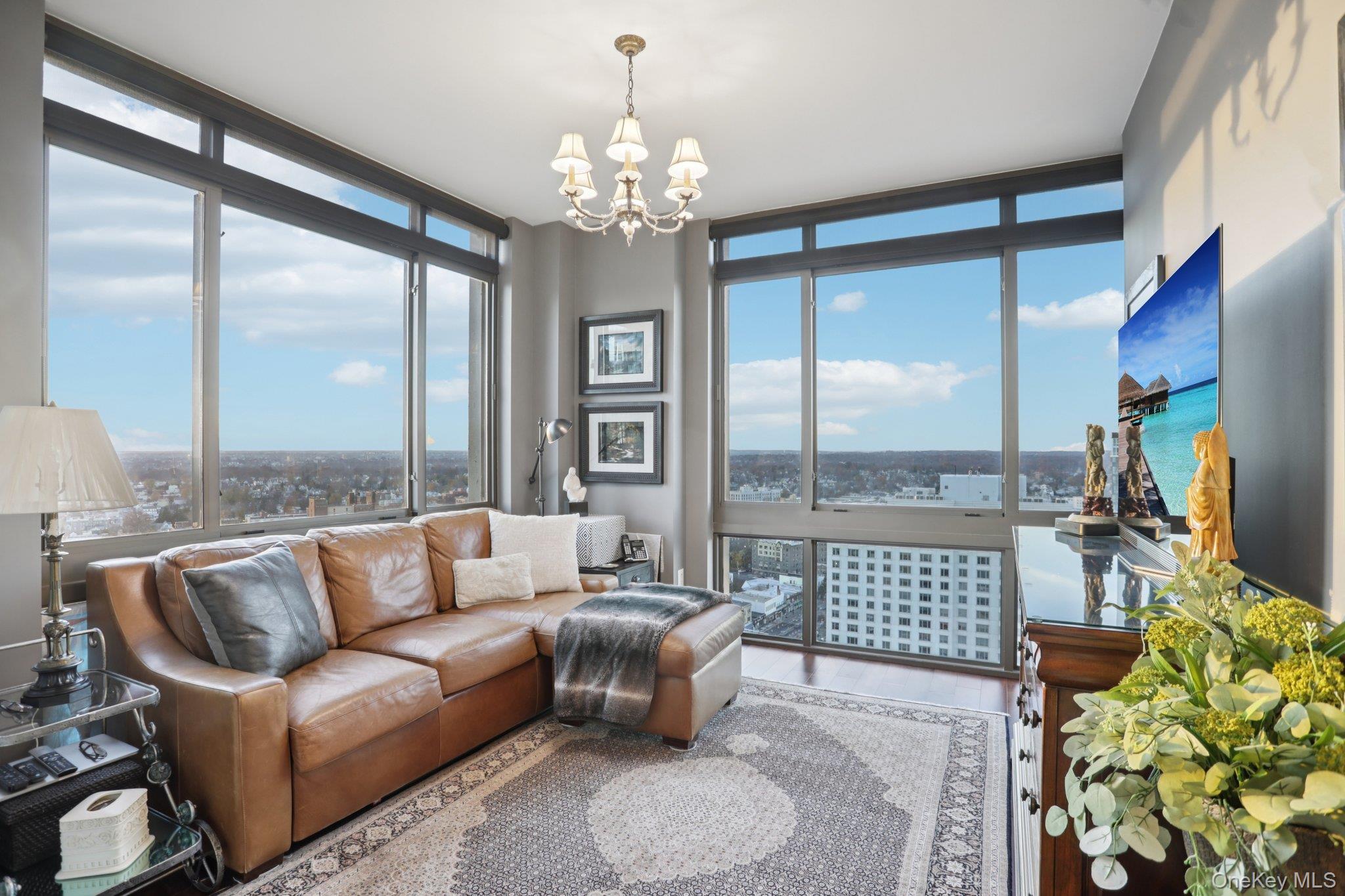 175 Huguenot Street, Unit 2403 New Rochelle, NY 10801 - Photo 9 of 30 a living room with patio furniture and a large window