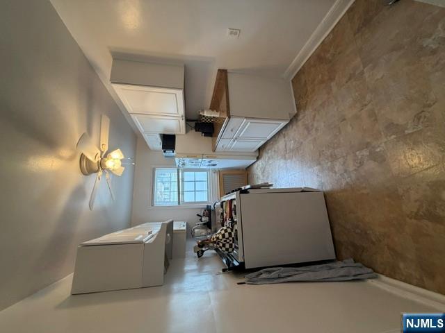 2-8 New Street, Unit 8A Tenafly, NJ 07670 - Photo 14 of 29 a room with furniture and a ceiling fan