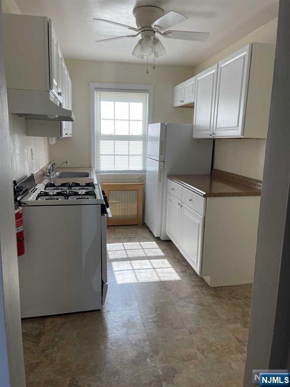 2-8 New Street, Unit 8A Tenafly, NJ 07670 - Photo 15 of 29 a kitchen with a stove a sink and a refrigerator