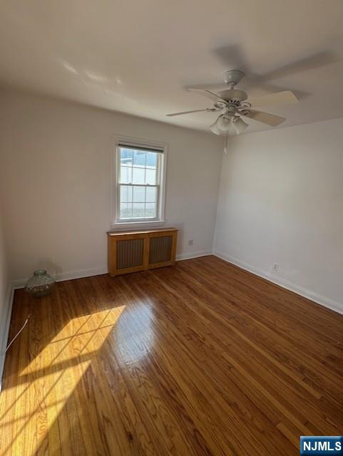 2-8 New Street, Unit 8A Tenafly, NJ 07670 - Photo 19 of 29 a view of empty room with wooden floor and fan