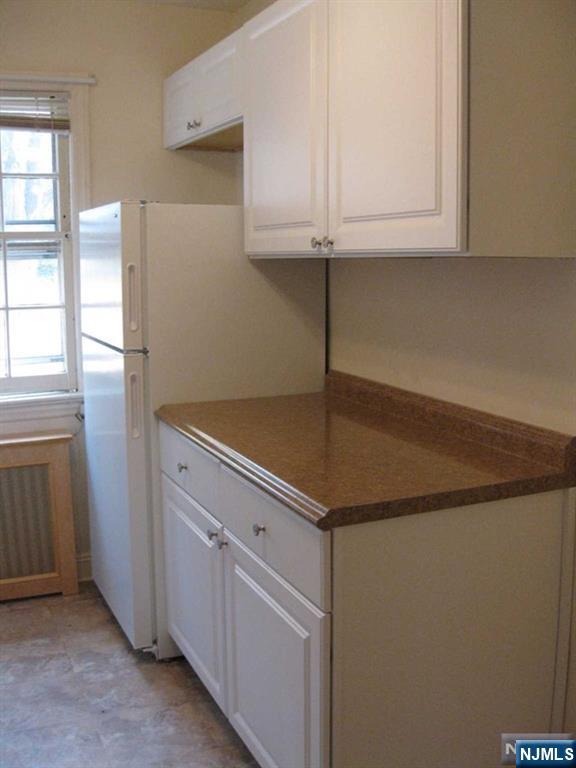2-8 New Street, Unit 8A Tenafly, NJ 07670 - Photo 10 of 29 a kitchen with a sink and cabinets