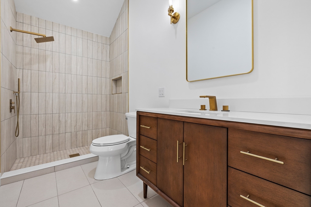 1 Knollwood Road Marblehead, MA 01945 - Photo 11 of 24 a bathroom with a toilet a sink and mirror