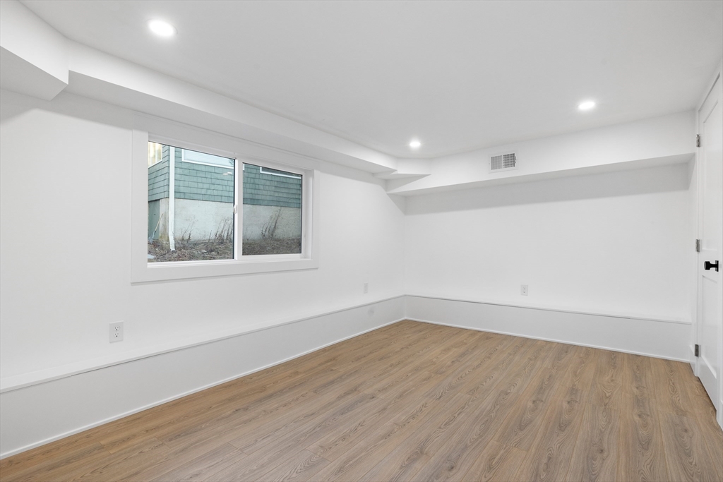 1 Knollwood Road Marblehead, MA 01945 - Photo 20 of 24 an empty room with wooden floor and windows