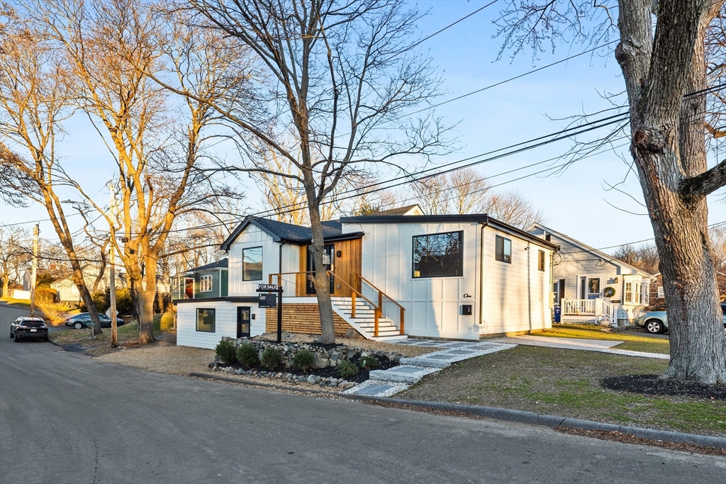 1 Knollwood Road Marblehead, MA 01945 - Photo 2 of 24 a front view of a house with a yard and garage