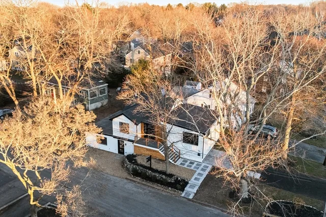 an aerial view of a house with a yard