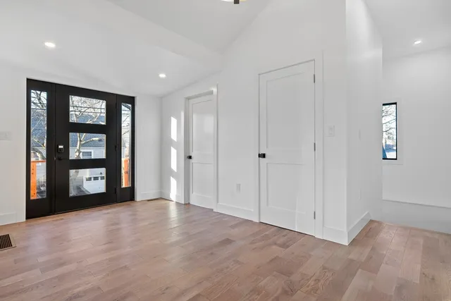 an empty room with windows and closet