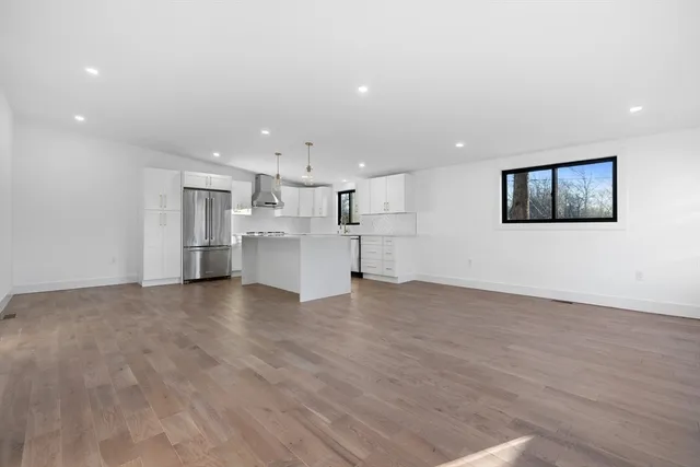 a view of a kitchen with a sink and a refrigerator