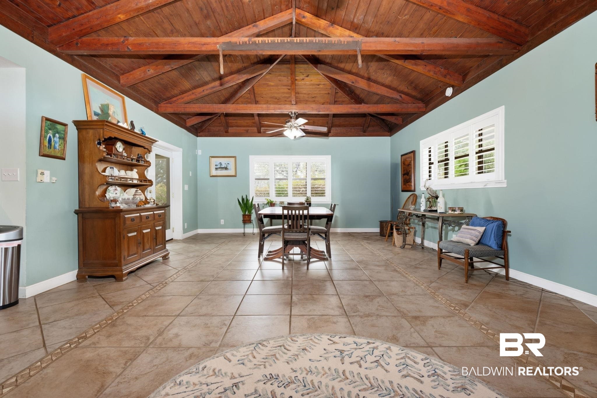 15025 Bellingrath Road Coden, AL 36523 - Photo 34 of 79 Dining area with a high wooden beamed ceiling, a ceiling fan, and light tile patterned floors