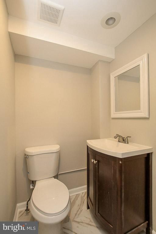 18 West Franklin Street Baltimore, MD 21201 - Photo 14 of 58 a bathroom with a toilet a sink and mirror