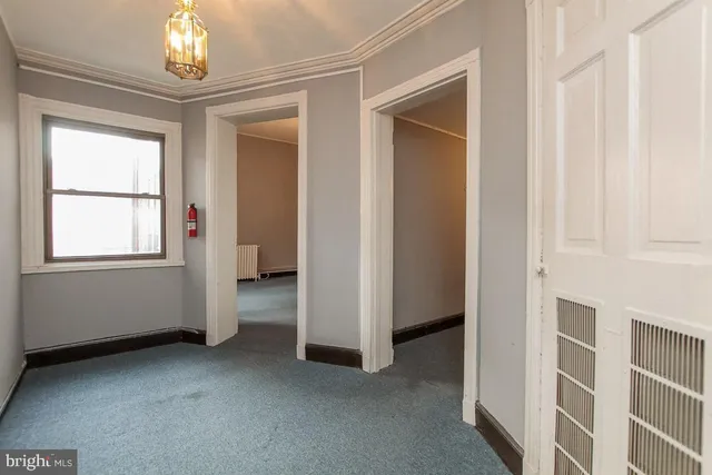 a view of empty room with fireplace and fan