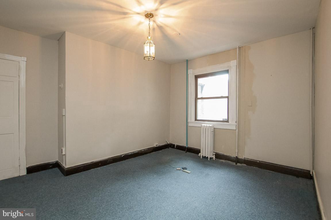 18 West Franklin Street Baltimore, MD 21201 - Photo 17 of 58 an empty room with a window and a fan