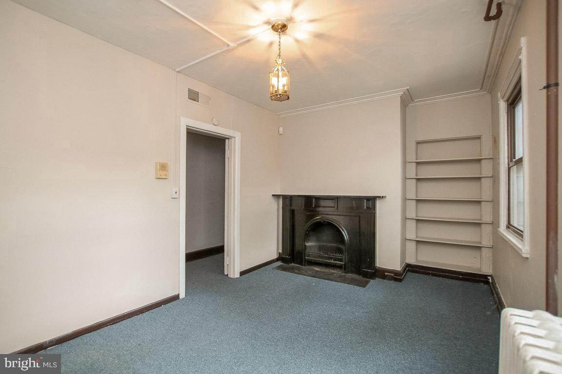 18 West Franklin Street Baltimore, MD 21201 - Photo 18 of 58 a view of empty room with fireplace and fan